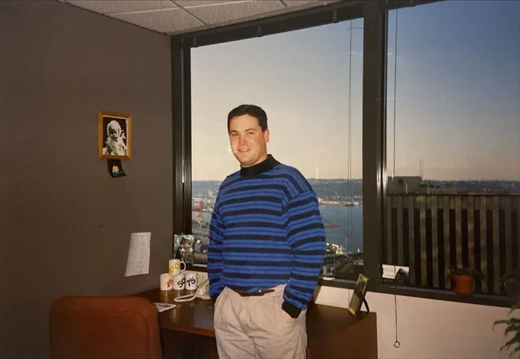 Nate Walters early in his career at a Seattle office overlooking the harbor at sunset